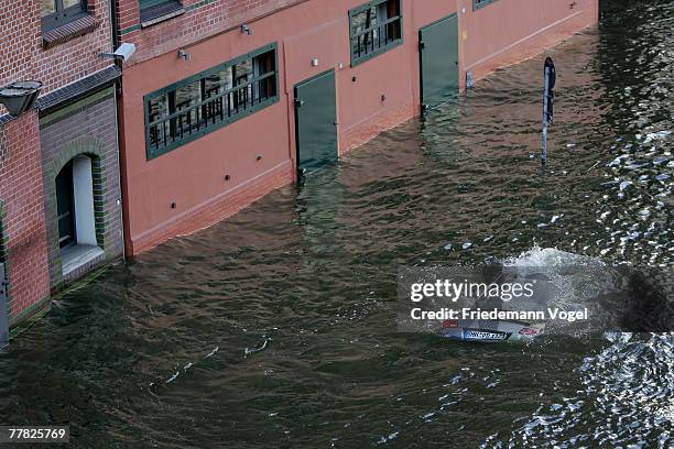 Sinking car is seen at the Fischmarkt during the flood on November 9, 2007 in Hamburg, Germany.