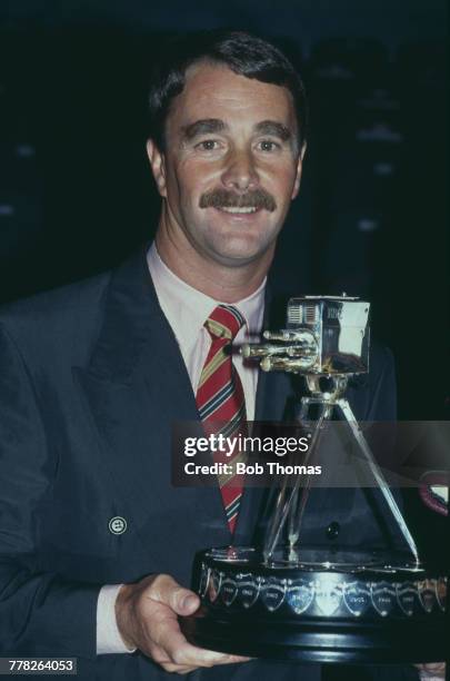 British racing driver Nigel Mansell holds the trophy after winning the 1992 BBC Sports Personality of the Year Award in London in December 1992.