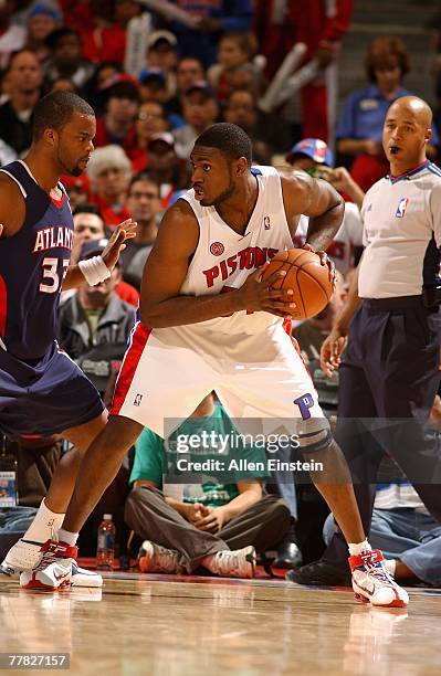 Jason Maxiell of the Detroit Pistons holds the ball away from Sheldon Williams of the Atlanta Hawks during the game on November 4, 2007 at The Palace...