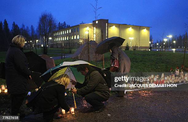 People set alight candles outside Jokela school , in Tuusaula, Finland, 09 November 2009, near the crime scene two days after Finn student Pekka-Eric...