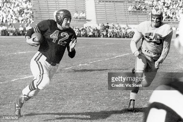 Quarterback Sid Luckman of the Chicago Bears runs past end Tom Fears of the Los Angeles Rams during a game played on November 7, 1948 at the Los...