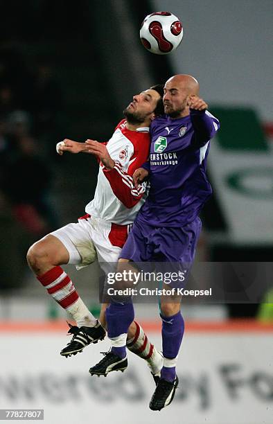 Thomas Broich of Cologne and Skerdilaid Curri of Aue go up for a header during the Second Bundesliga match between 1. FC Cologne and Erzgebirge Aue...