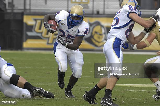 Running back Tarrion Adams of the Tulsa Golden Hurricane rushes upfield against the University of Central Florida Knights at Bright House Stadium on...