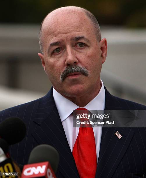 Bernard Kerik stands near microphones after speaking to the media following a court appearance on corruption charges November 9, 2007 in White...