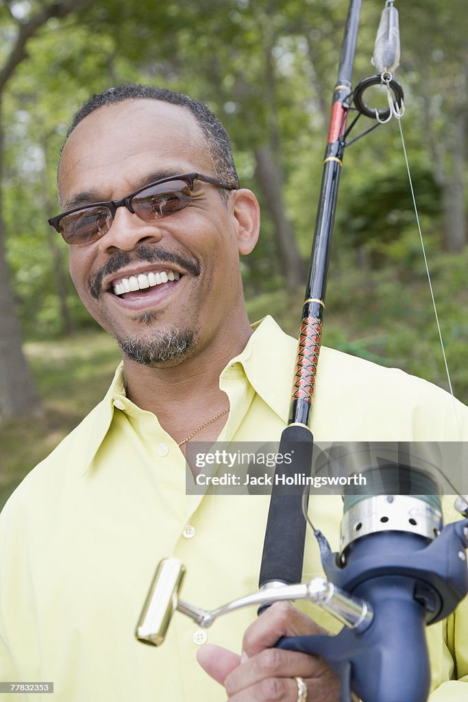 Mature man holding a fishing rod