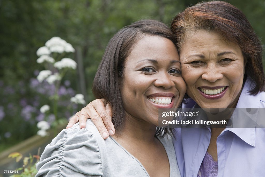 Portrait of a senior woman and her daughter smiling