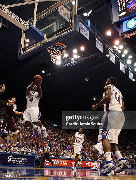 Sherron Collins of the Kansas Jayhawks shoots over Lance Brasher of the Louisiana Monroe Warhawks during the second half of the game on November 9,...