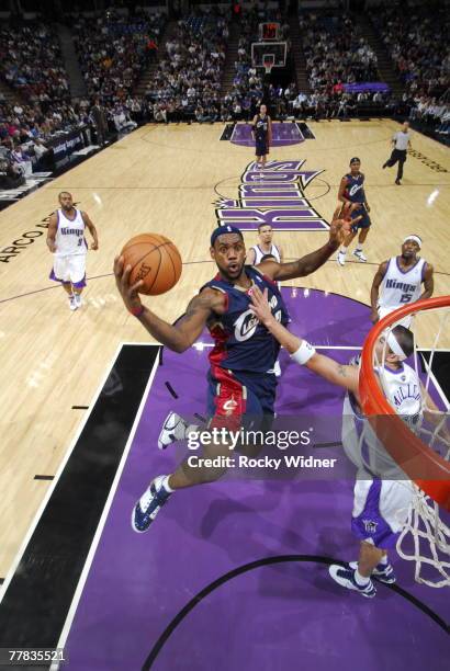 Lebron James of the Cleveland Cavaliers goes up for the shot against Brad Miller of the Sacramento Kings on November 9, 2007 at ARCO Arena in...