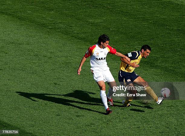 John Aloisi of the Mariners is defended by Milan Susak of the United during the round twelve A-League match between the Central Coast Mariners and...
