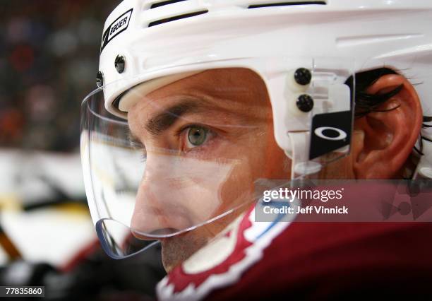 Joe Sakic of the Colorado Avalanche watches the play from the bench during their game against the Vancouver Canucks at General Motors Place on...