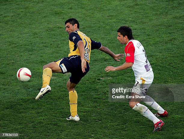 John Aloisi of the Mariners is defended by Milan Susak of the United during the round twelve A-League match between the Central Coast Mariners and...