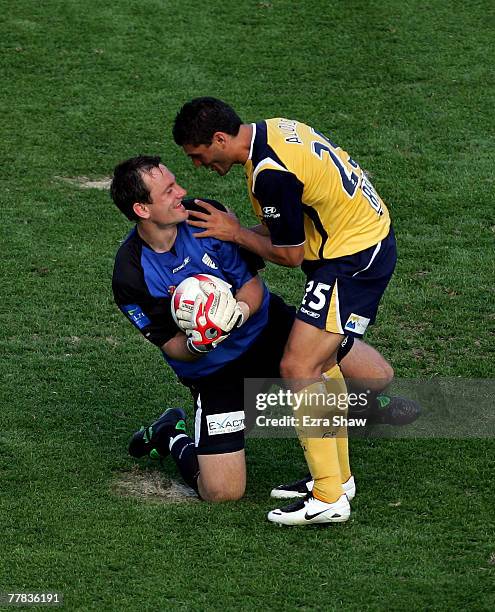 John Aloisi of the Mariners jokes with Eugene Galekovic of the United after Galekovic made a save during the round twelve A-League match between the...