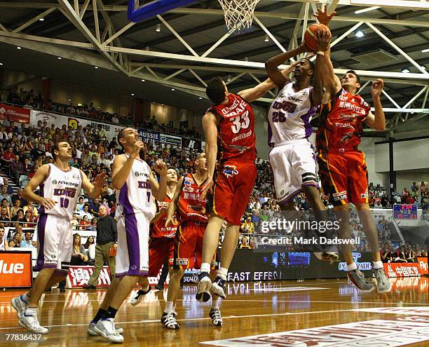 Isiah Victor of the Kings shoots under pressure from Stephen Hoare and Chris Anstey of the Tigers during the round eight NBL match between the...