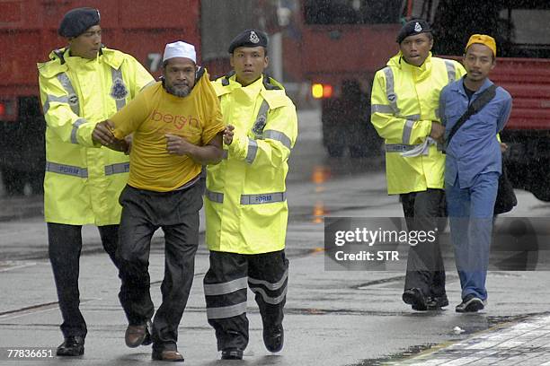 Arrested demonstrators are led away by police officers in the Masjid Jamek area of downtown Kuala Lumpur, 10 November 2007. Malaysian police...