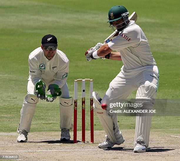 South Africa's batsman Jacques Kallis plays a shot off the ball of New Zealand's bowler Daniel Vettori as Wicketkeeper Brendon McCullum waits to make...