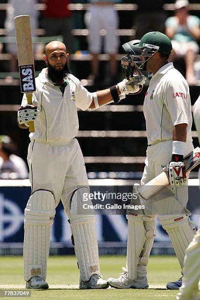 Hashim Amla of South Africa celebrates his 100 with Jacques Kallis during day three of the 1st test match between South Africa and New Zealand held...