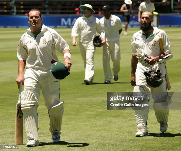 Jacques Kallis and Hashim Amla of South Africa leave the field during day three of the 1st test match between South Africa and New Zealand held at...