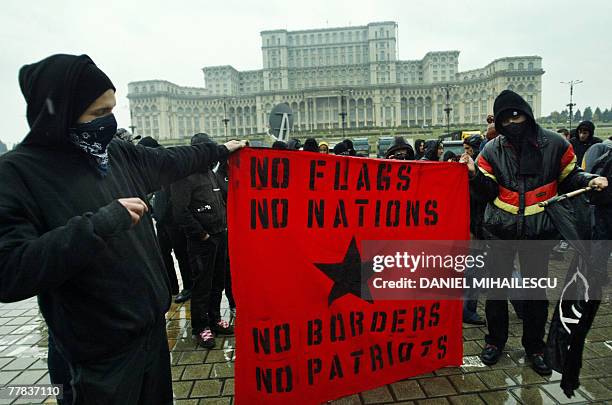 Anti-far right protesters hold a banner in the front of the Romanian Parliament house, 10 November 2007 during a anti-discrimination protest in...