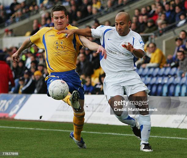 Gary Holloway of Lewes and Lee Bell of Mansfield challenge for the ball during the FA Cup sponsored by Eon First Round match between Mansfield Town...