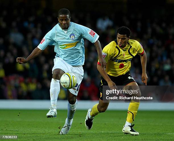 Kevin Lisbie of Colchester holds off the challenge of Adrian Mariappa of Watford during the Coca-Cola Championship match between Watford and...