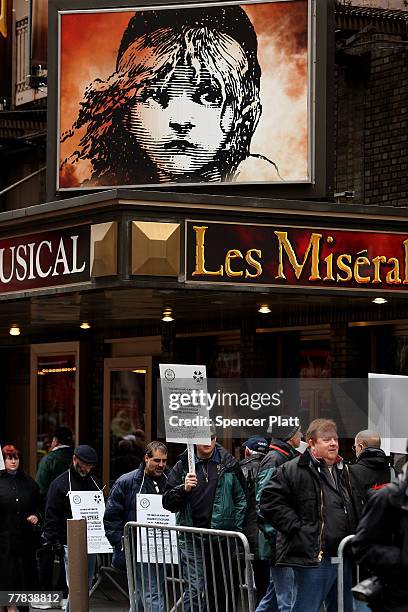 Strikers picket in front of a Les Miserables in the theater district on the first morning of a strike by Broadway stagehands forcing producers to...