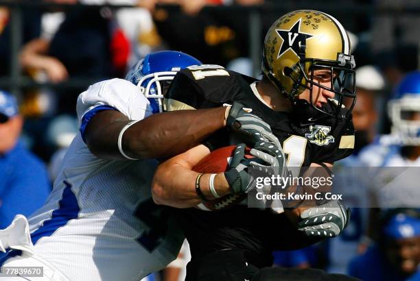 Linebacker Micah Johnson of the Kentucky Wildcats wraps up tailback Jared Hawkins of the Vanderbilt Commodores during the first half at Vanderbilt...