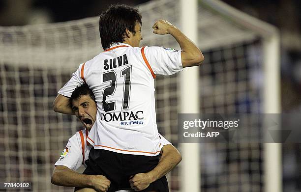 Valencia's David Villa celebrates his second goal with David Silva during their Spanish league football match at Mestalla Stadium in Valencia, 10...