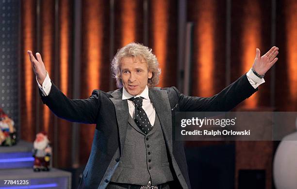 German TV host Thomas Gottschalk gestures during the live-broadcast of his TV show 'Wetten, dass...?' at Leipzig Messehalle November 10, 2007 in...