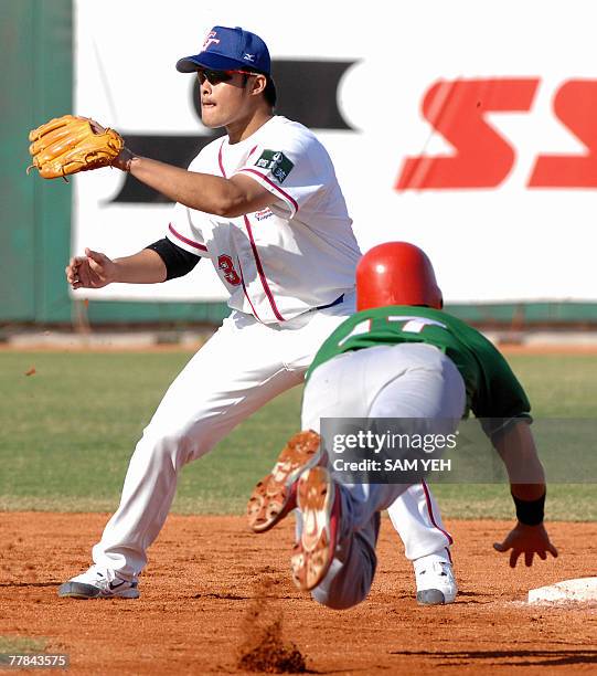 Taiwan's Lin Chih-sheng takes the throw as Mexico's Lorenzo Buelna slides into second base during the 37th Baseball World Cup in Taichung, central...