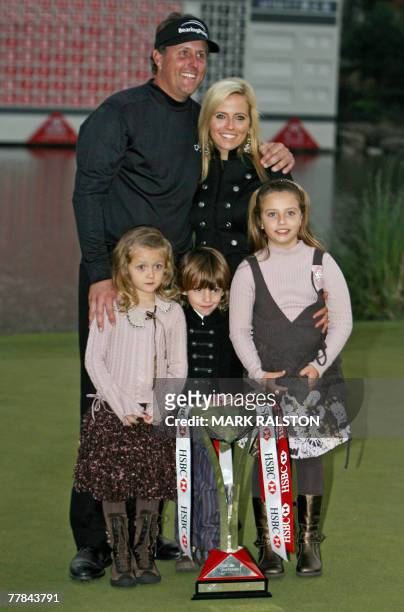 World number two Phil Mickelson from the US poses with his wife Amy and children Sophia Isabel, Evan and Amanda Brynn with the trophy after winning...