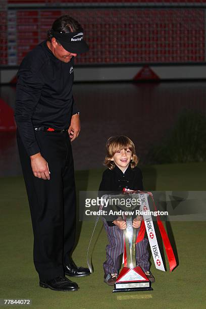 Phil Mickelson of USA celebrates with his son Evan and the trophy after winning the HSBC Champions at the Sheshan Golf Club on November 11, 2007 in...