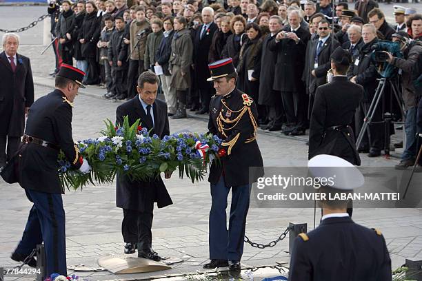 French President Nicolas Sarkozy lays a wreath at the tomb of the unknown soldier beneath the Arc de Triomphe during the Armistice Day ceremony in...