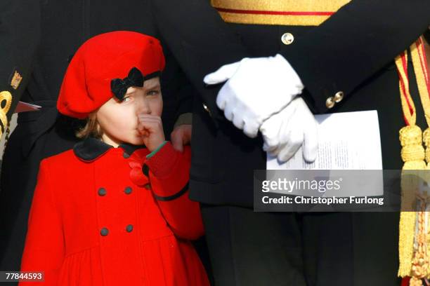 Sophie Bagot Jewitt, age 6, daughter of Lord Bagot, sucks her thumb as the first Remembrance Day service takes place at the Armed Forces Memorial at...