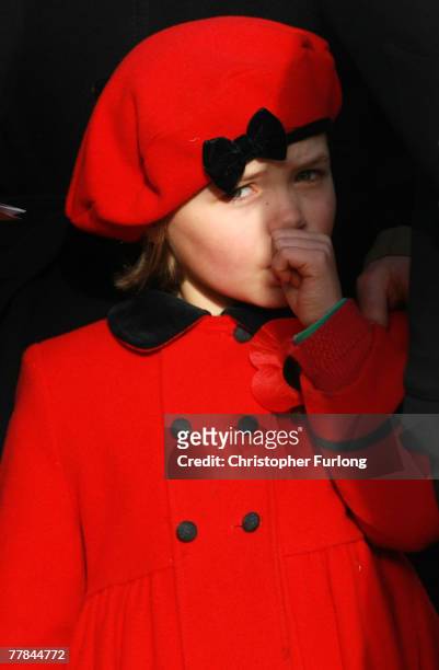 Sophie Bagot Jewitt, age 6, daughter of Lord Bagot, sucks her thumb as the first Remembrance Day service takes place at the Armed Forces Memorial at...