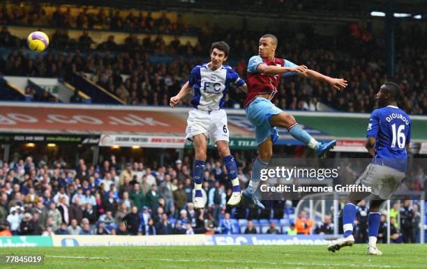 Gabriel Agbonlahor of Aston Villa scores the second goal under pressure from Liam Ridgewell of Birmingham during the Barclays Premier League match...