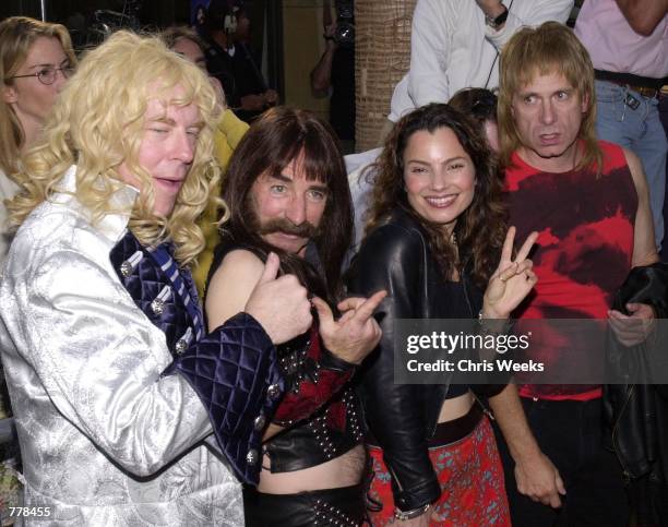 Actress Fran Drescher, 2nd right, poses for photographers with members of "Spinal Tap" David St. Hubbins, left, Derek Smalls, and Nigel Tufnel,...