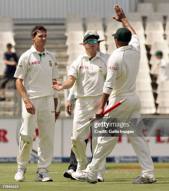 Dale Steyn looks on as Herschelle Gibbs and Ashwell Prince celebrate during day four of the 1st test match between South Africa and New Zealand held...