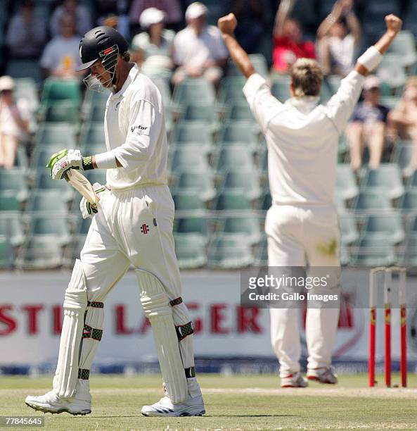 Jacob Oram walks off dejected as Paul Harris celebrates during day four of the 1st test match between South Africa and New Zealand held at the...