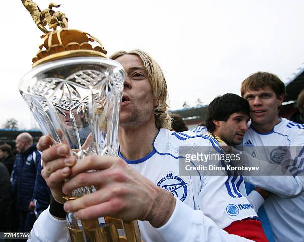 Anatoly Timoshuk, a captain of Zenit St. Petersburg's kisses a trophy as they celebrate a victory in Russia's Premier league football championship in...