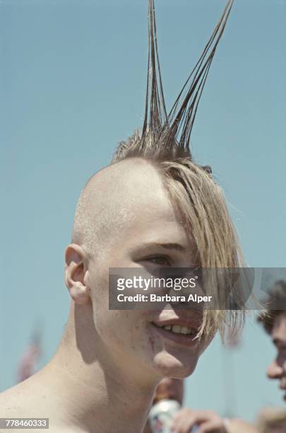 Young man with a spiked mohawk hairstyle at a PETA demonstration in Washington DC, June 1988.