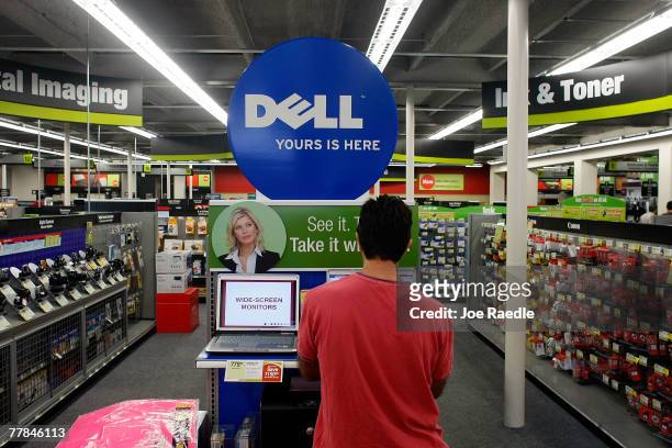 Jorge Bascha looks at a Dell computer on sale at a Staples store November 11, 2007 in Miami, Florida. Dell Inc. Today began selling computers and...