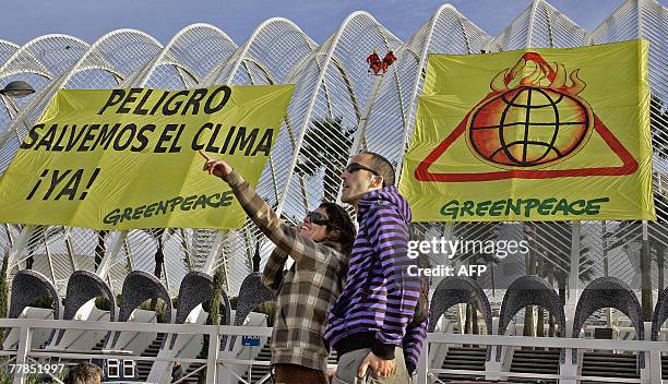 Members of ecological action group Greenpeace unfold a banner during the opening of the Intergovernmental Panel on Climate Change in Valencia, 12...