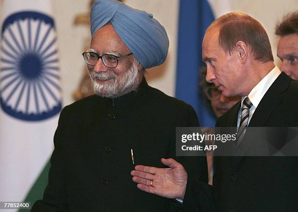 Russian President Vladimir Putin welcomes Indian Prime Minister Manmohan Singh during their meeting at the Kremlin in Moscow, 12 November 2007....
