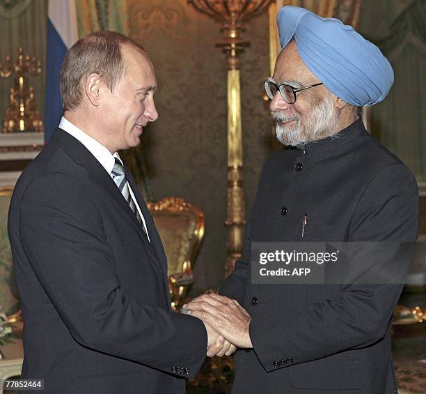 Russian President Vladimir Putin welcomes Indian Prime Minister Manmohan Singh during their meeting at the Kremlin in Moscow, 12 November 2007....