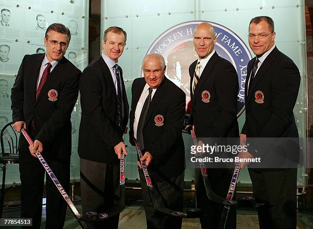 Ron Francis, Al MacInnis, Jim Gregory, Mark Messier and Scott Stevens pose with hockey sticks at the Hockey Hall of Fame press conference and photo...