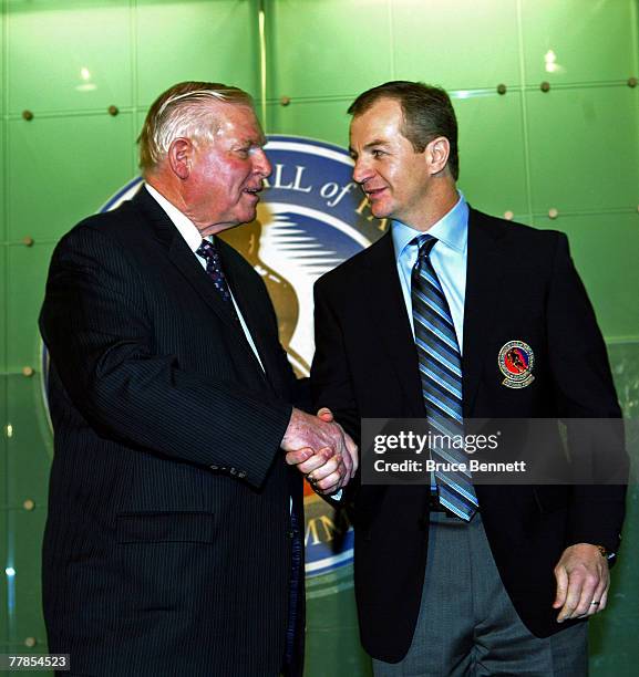 Chairman of the Hockey Hall of Fame Bill Hay presents the Hall ring to Al MacInnis at the Hockey Hall of Fame press conference and photo opportunity...