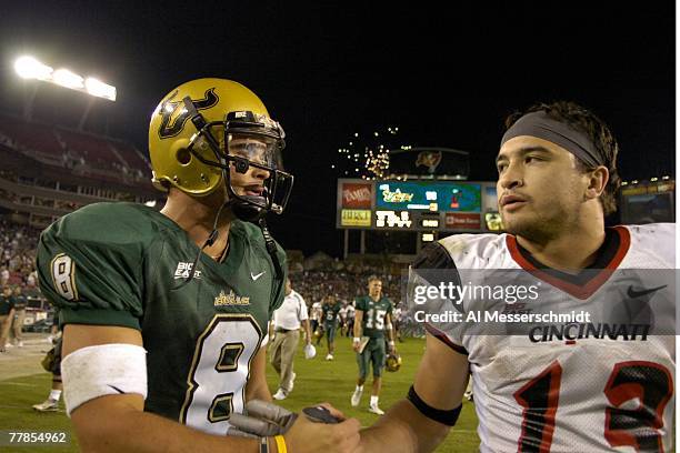 Quarterback Matt Grothe of the University of South Florida Bulls greets defensive back Haruki Nakamura of the Cincinnati Bearcats at Raymond James...