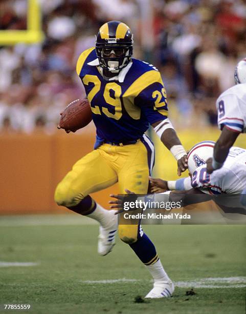 Los Angeles Rams running back Eric Dickerson , inducted into the Pro Football Hall of Fame class of 1999, carries the ball during a 27-16 victory...