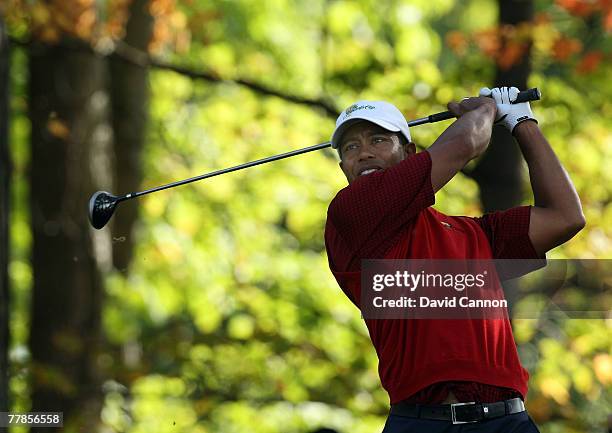 Tiger Woods of the U.S. Team plays his tee shot at the 15th hole during the final day singles matches at the Presidents Cup at Royal Montreal Golf...