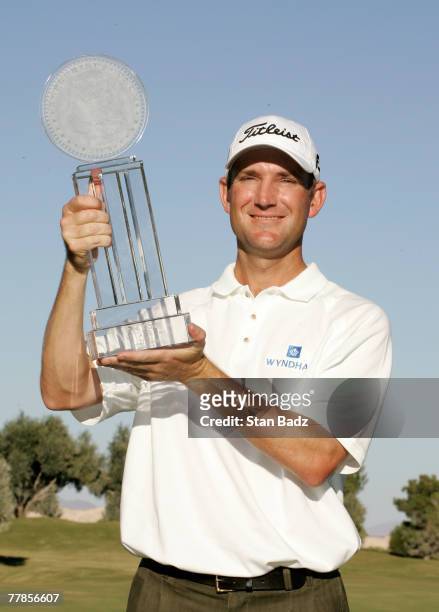 George McNeill holds the winner's trophy after the fourth round of the Frys.com Open benefiting Shriners Hospitals for Children at TPC Summerlin...